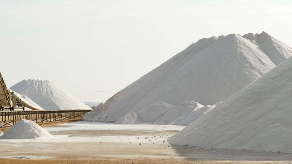 Industrial bulk salt mountains at a salt distribution facility